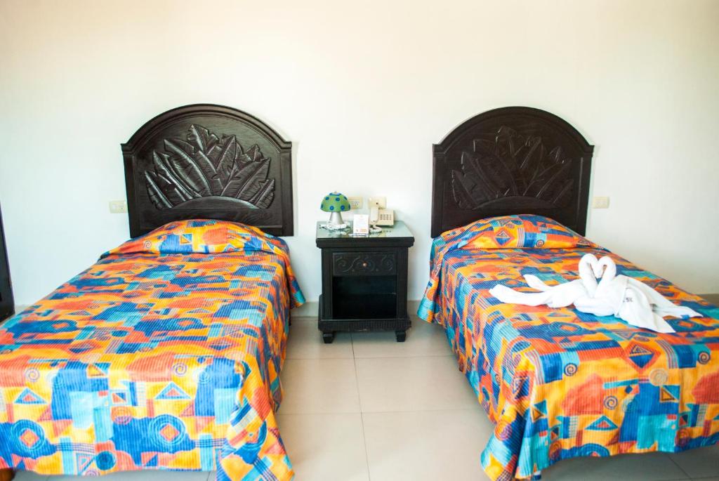 Postel nebo postele na pokoji v ubytování Hotel Del Sol