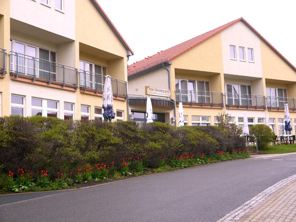a row of buildings with flowers in front of a street at Hotel Am Heidepark in Dippoldiswalde