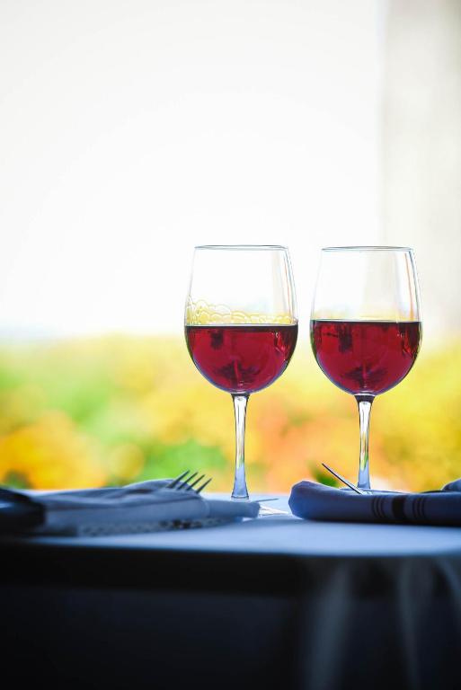 two glasses of red wine sitting on a table at The Lakehouse Inn Geneva in Geneva-on-the-Lake