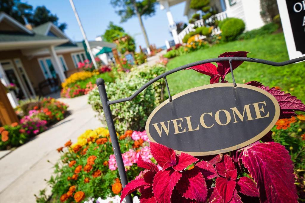 a sign that reads welcome in a garden at The Lakehouse Inn Geneva in Geneva-on-the-Lake