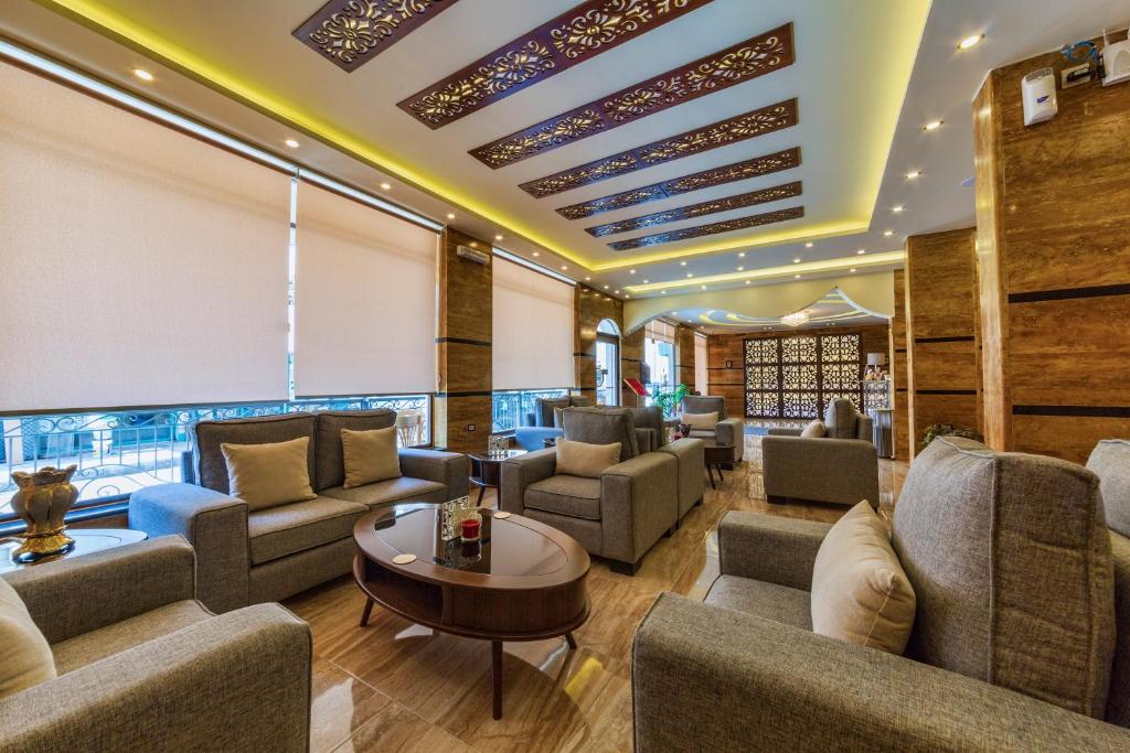 a living room filled with furniture and a large window at Town Season Hotel in Wadi Musa