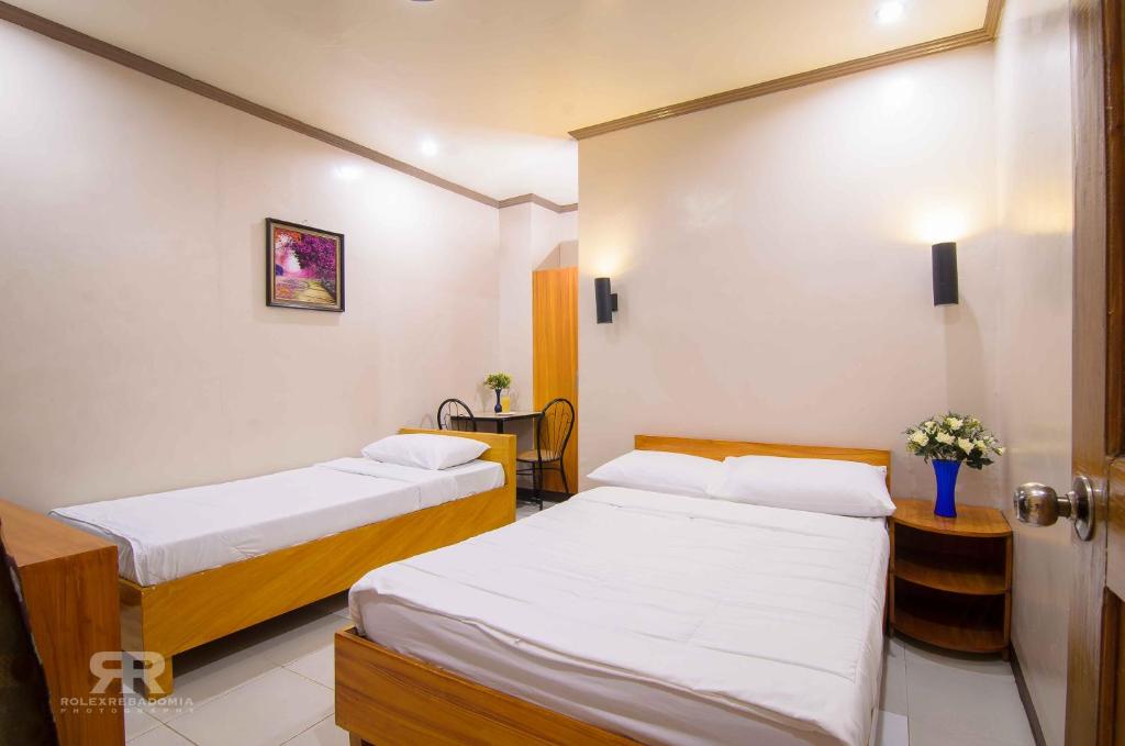Postel nebo postele na pokoji v ubytování Diamond Hotel And Resto