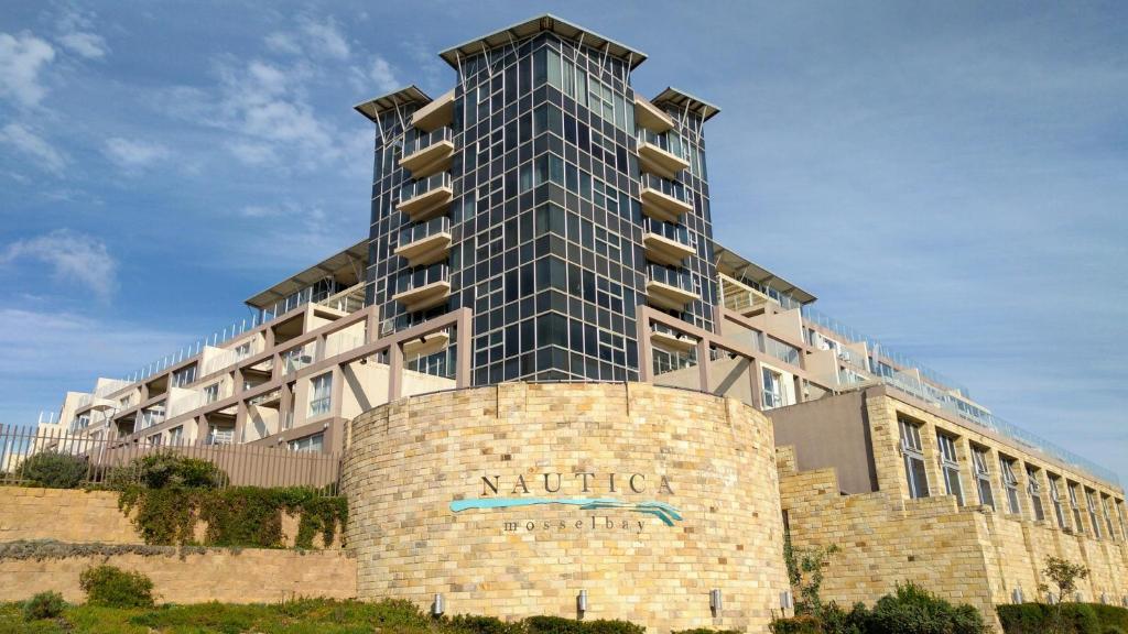 a large building with a sign in front of it at Nautica 410 in Mossel Bay