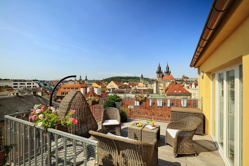 
a stone wall with a bench and a building at Grand Hotel Bohemia in Prague
