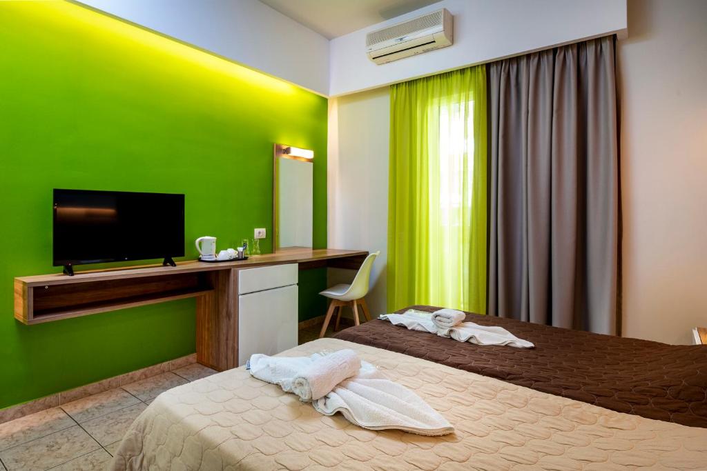 Postel nebo postele na pokoji v ubytování Olympia Hotel