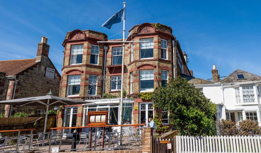 a large brick building with a flag on it at The Seaview Hotel And Restaurant in Seaview