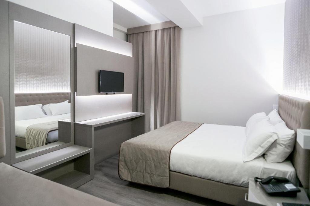 Postel nebo postele na pokoji v ubytování Hotel Principe