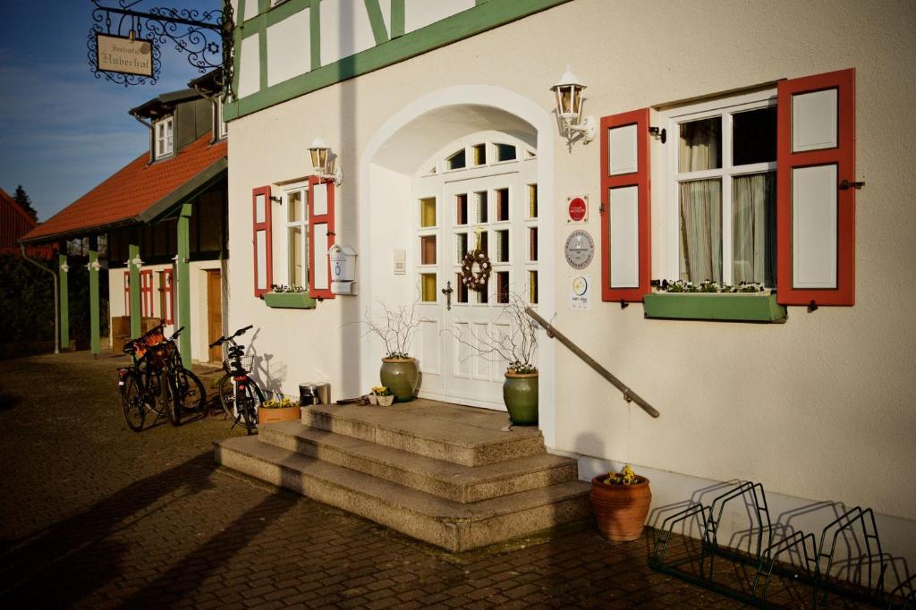 a building with stairs in front of a building at Seehotel Huberhof in Seehausen