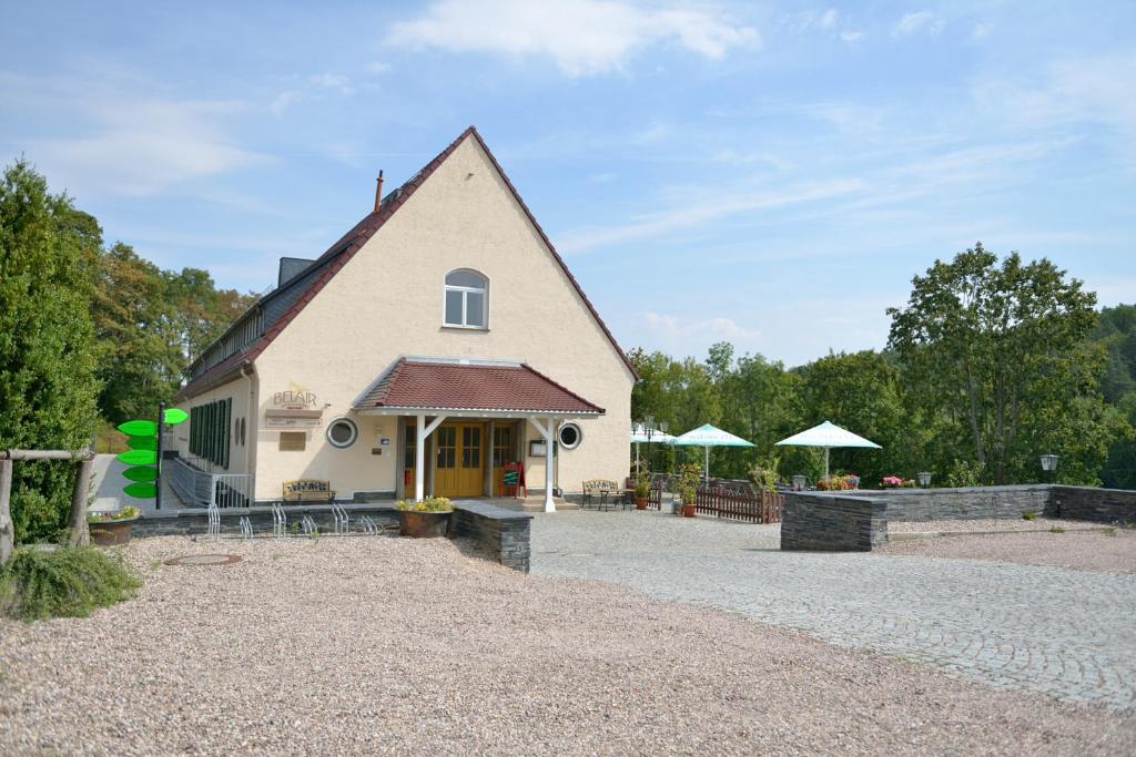 a large white building with a roof at Land- und Golfhotel Alte Fliegerschule in Eisenach