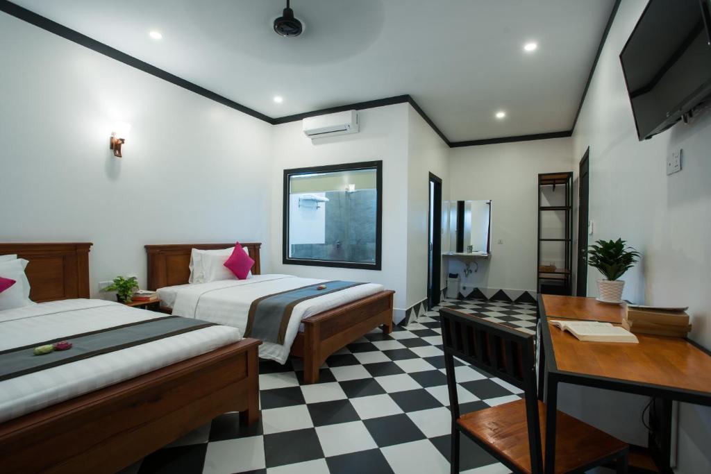 Postel nebo postele na pokoji v ubytování Noni Tree Hostel