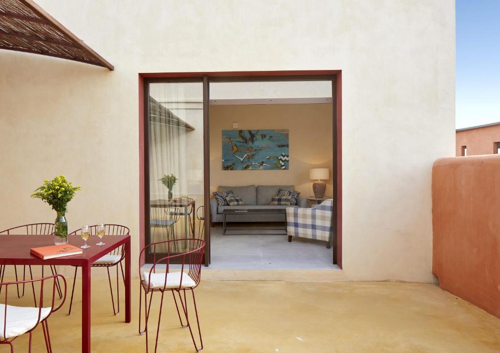 a living room with a table and chairs and a couch at Trafalgar Polo Club in El Palmar