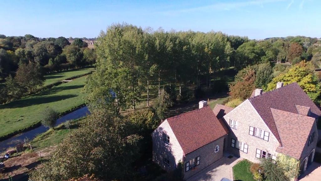 an overhead view of a house with a river and trees at Charmes de Velupont with Wellness in Braives