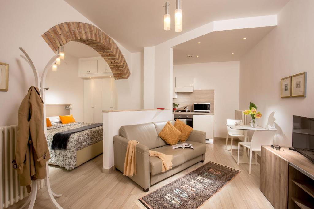 een slaapkamer en een woonkamer met een bed en een bank bij Vatican Studio Apartment in Rome