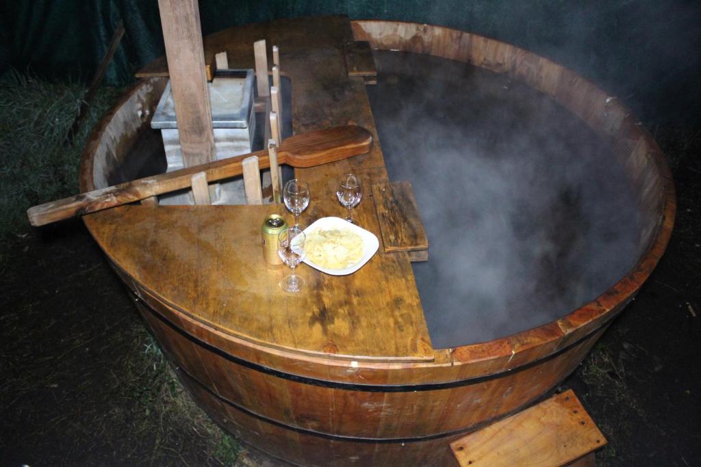 a wooden wine barrel with wine glasses and smoke at Cabana Quillon in Quillón