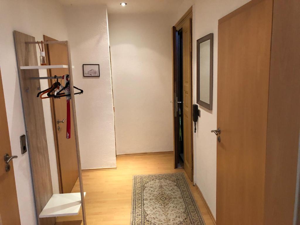 a room with a hallway with a door and a rug at Süd-Apartments in Leipzig