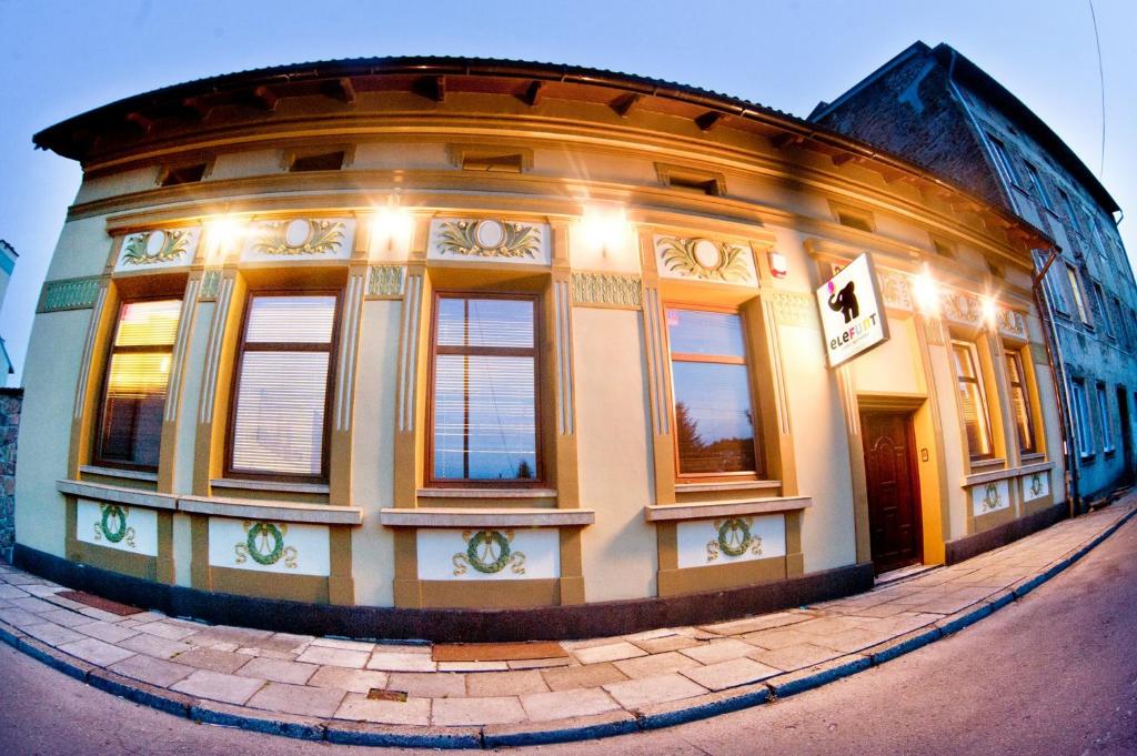 a large round building with windows on a street at Guesthouse Prusa 7 in Oświęcim