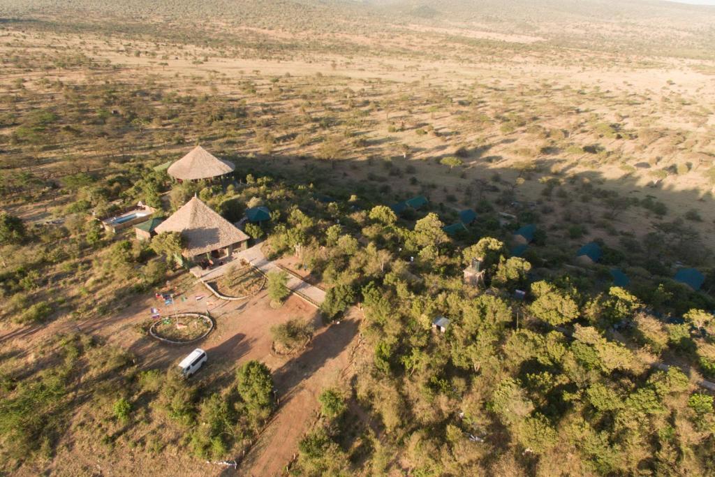 an aerial view of a house in the middle of a field at La Maison Royale Masai Mara in Sekenani