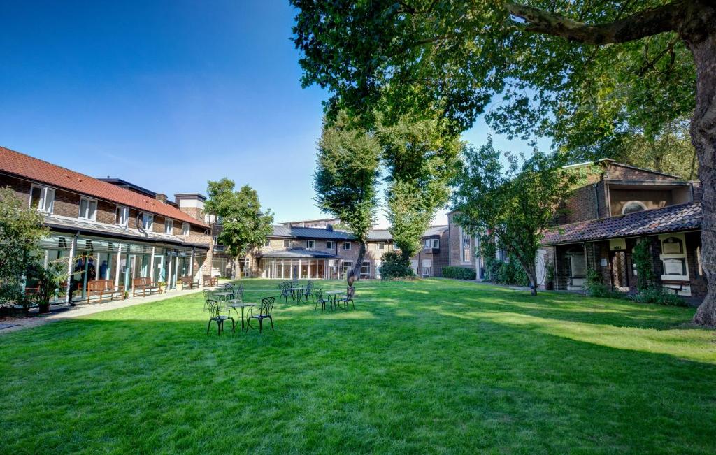 a row of tables on a lawn in a courtyard at The Royal Foundation of St Katharine in London