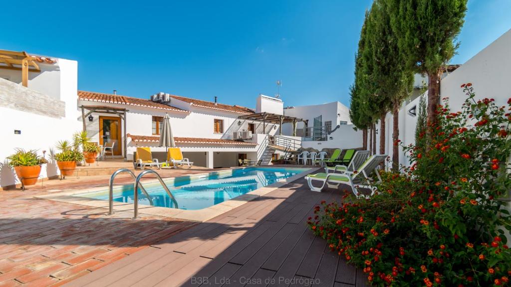 a villa with a swimming pool in a resort at Casa de Pedrógão in Pedrógão