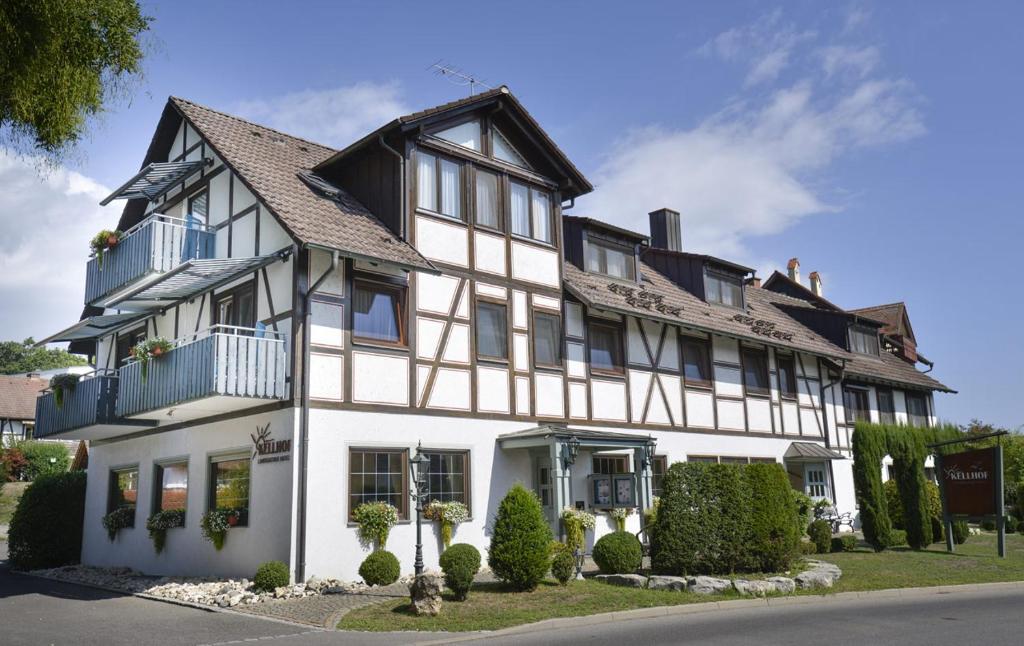 a large white building with a black roof at Hotel Kellhof - Bed & Breakfast in Gaienhofen
