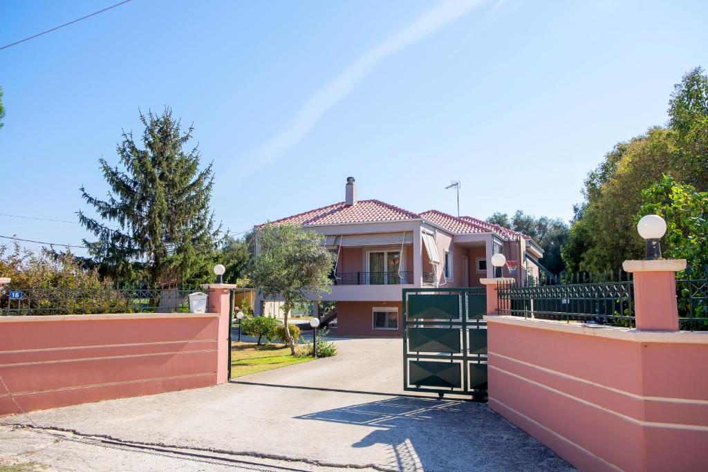 a house with a gate in front of a driveway at Villa DK in Preveza
