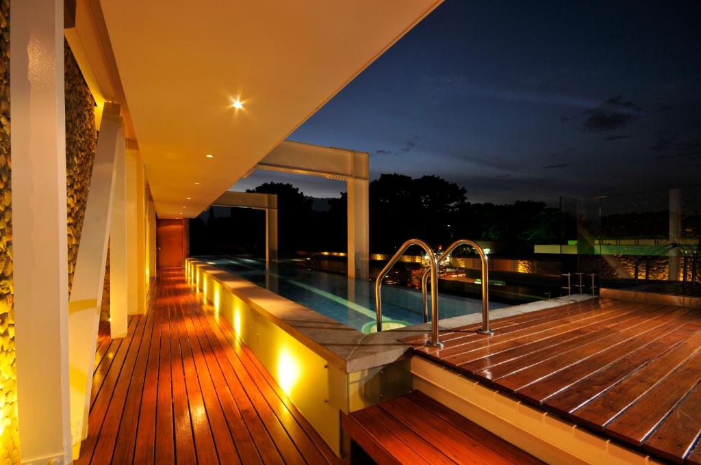 a swimming pool on the deck of a house at night at AcquaSanta Lofts Hotel in Cali
