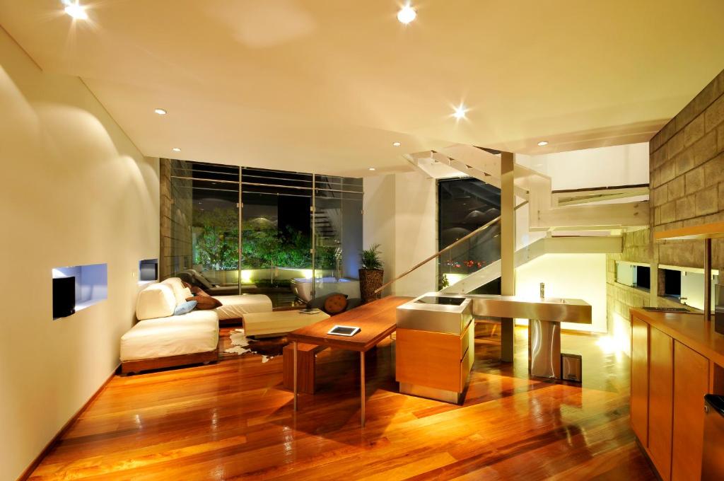 a living room with a couch and a piano at AcquaSanta Lofts Hotel in Cali