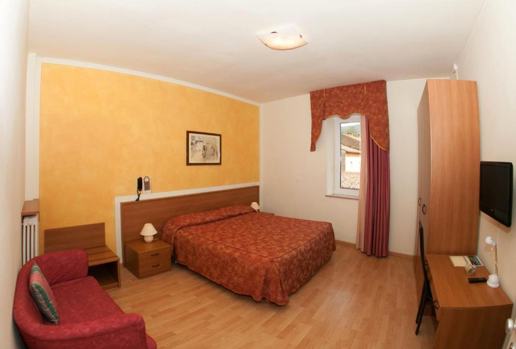 Postel nebo postele na pokoji v ubytování Hotel Pinamonte