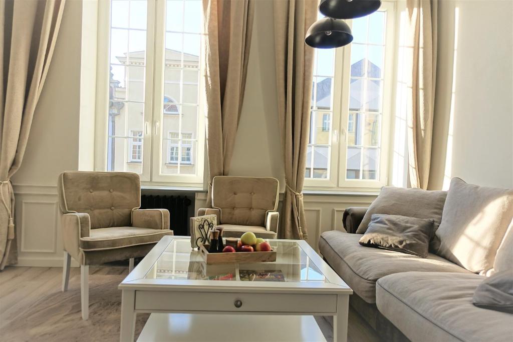 a living room with a couch and a coffee table at Tkacka Home in Gdańsk