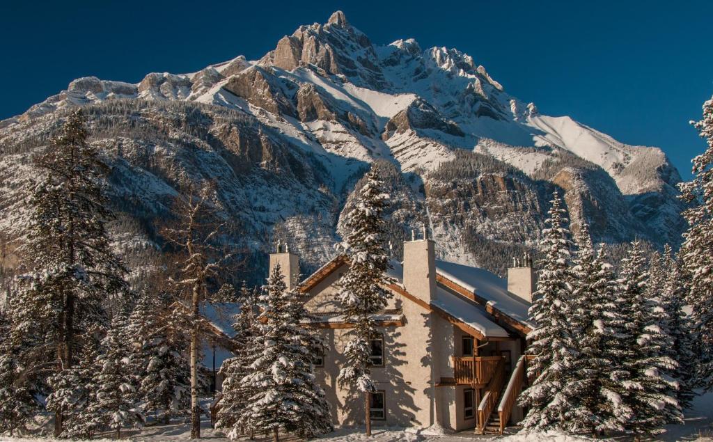 a ski lodge in front of a snow covered mountain at Banff Rocky Mountain Resort in Banff