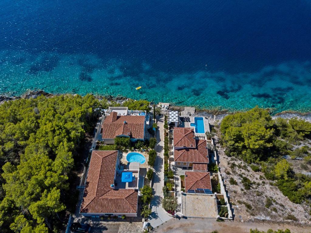 an aerial view of a house by the water at Villa Rosada in Vela Luka