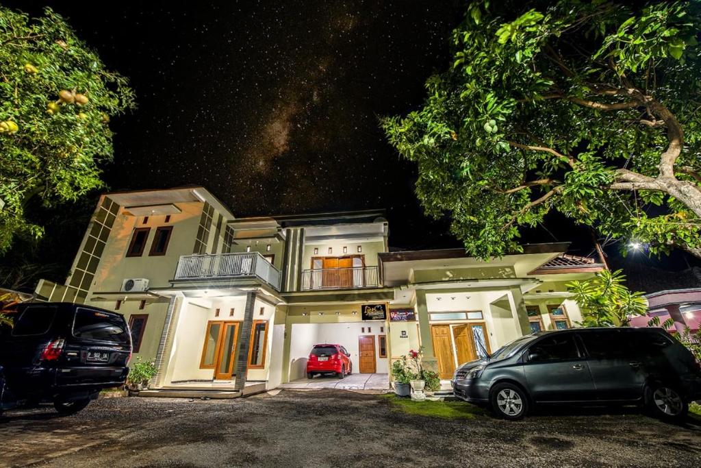 a car parked in front of a house at night at Ijen Bondowoso Home Stay in Bondowoso