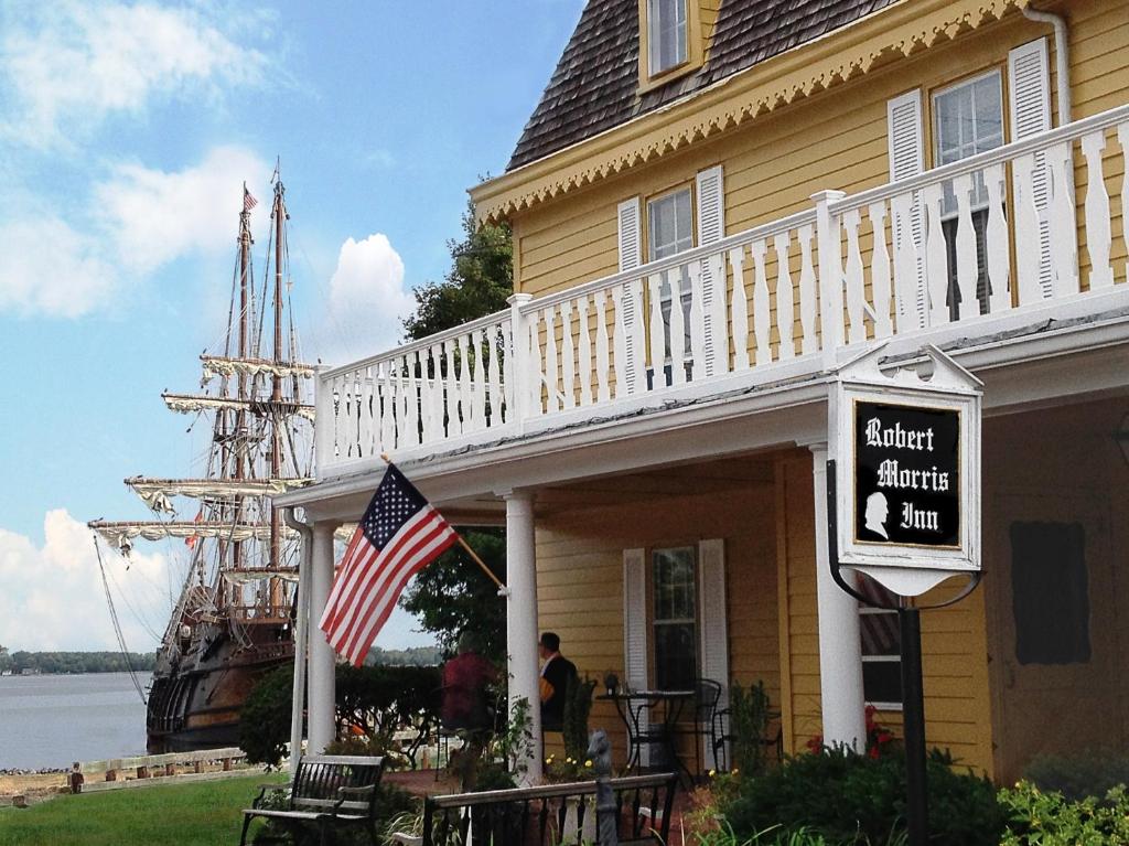 a house with an american flag and an old ship at The Robert Morris Inn in Oxford
