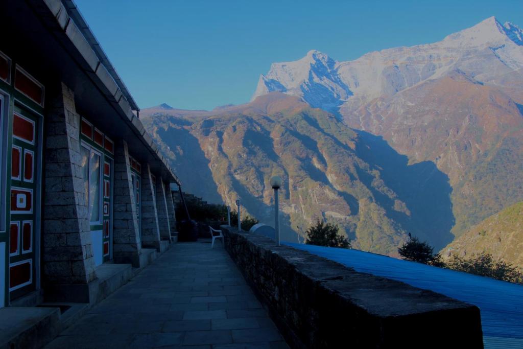 a building with a view of a mountain at Panorama Lodge and Restaurant in Nāmche Bāzār