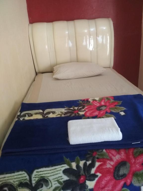 Postel nebo postele na pokoji v ubytování Sapo Karo Rest House