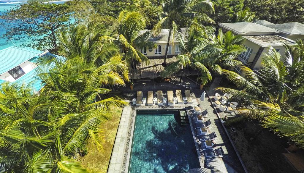 an aerial view of a resort with a swimming pool and palm trees at Talamba Blue in Blue Bay