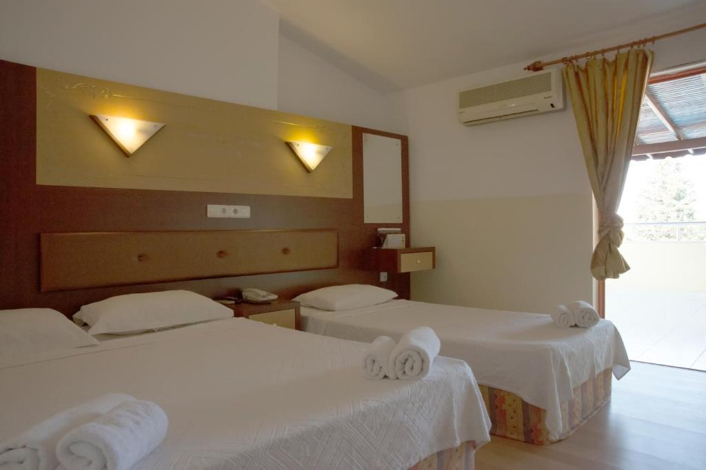 Postel nebo postele na pokoji v ubytování Wassermann Hotel