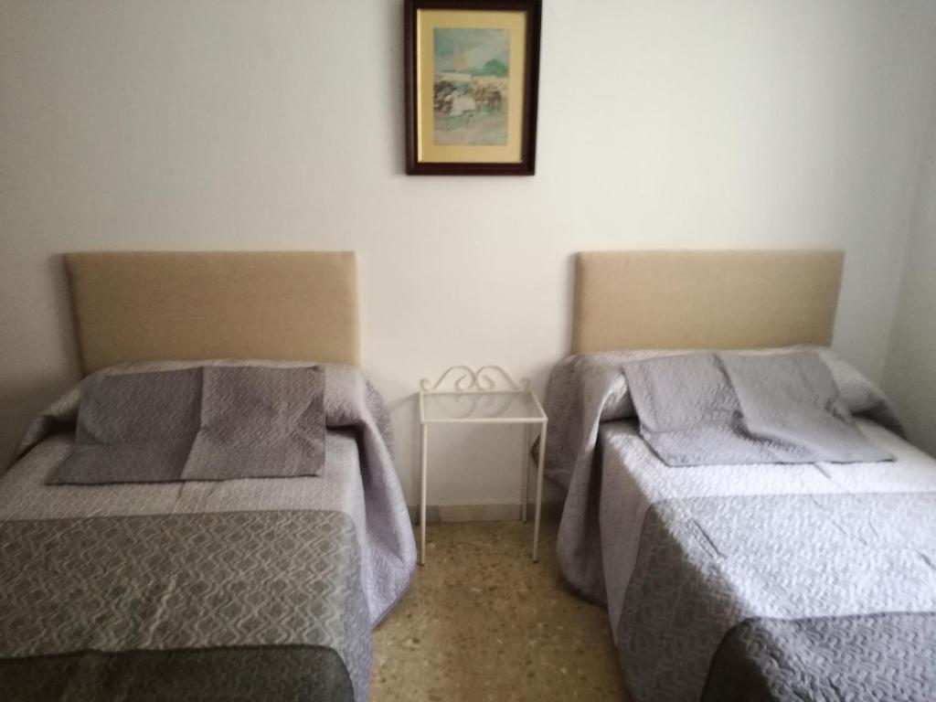 Postel nebo postele na pokoji v ubytování VIVIENDA COMPLETA EN SEVILLA
