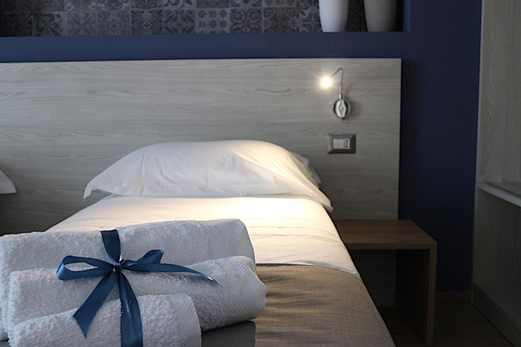 Łóżko lub łóżka w pokoju w obiekcie Musmelia Rooms