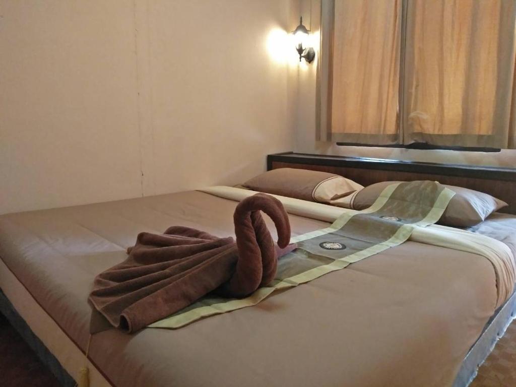 a bed with two towels sitting on top of it at Phi Phi Green Hill Resort in Phi Phi Don