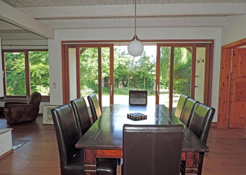 a dining room with a wooden table and chairs at Haus Katha Koserow in Ostseebad Koserow