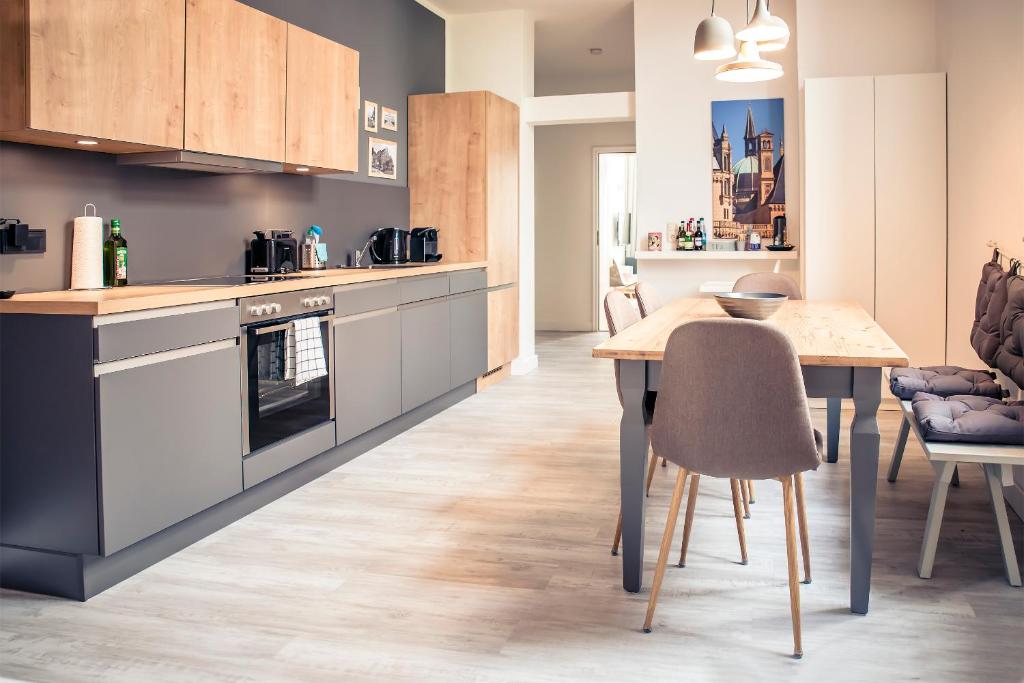 a kitchen with a table and a dining room at Schwerin City Apartment in Schwerin