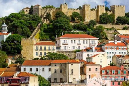 a group of buildings with a castle in the background at Lisbon Center Sweet Studio (Mouraria) in Lisbon