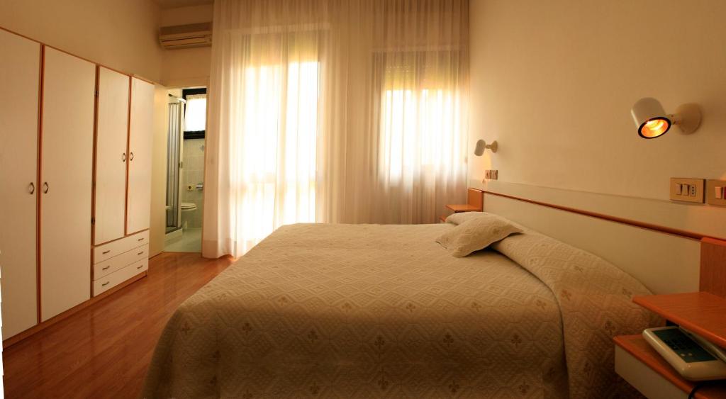 Postel nebo postele na pokoji v ubytování Hotel Aggravi
