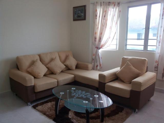 a living room with a couch and a glass table at D'Puncak Arabella Muslim Homestay in Cameron Highlands