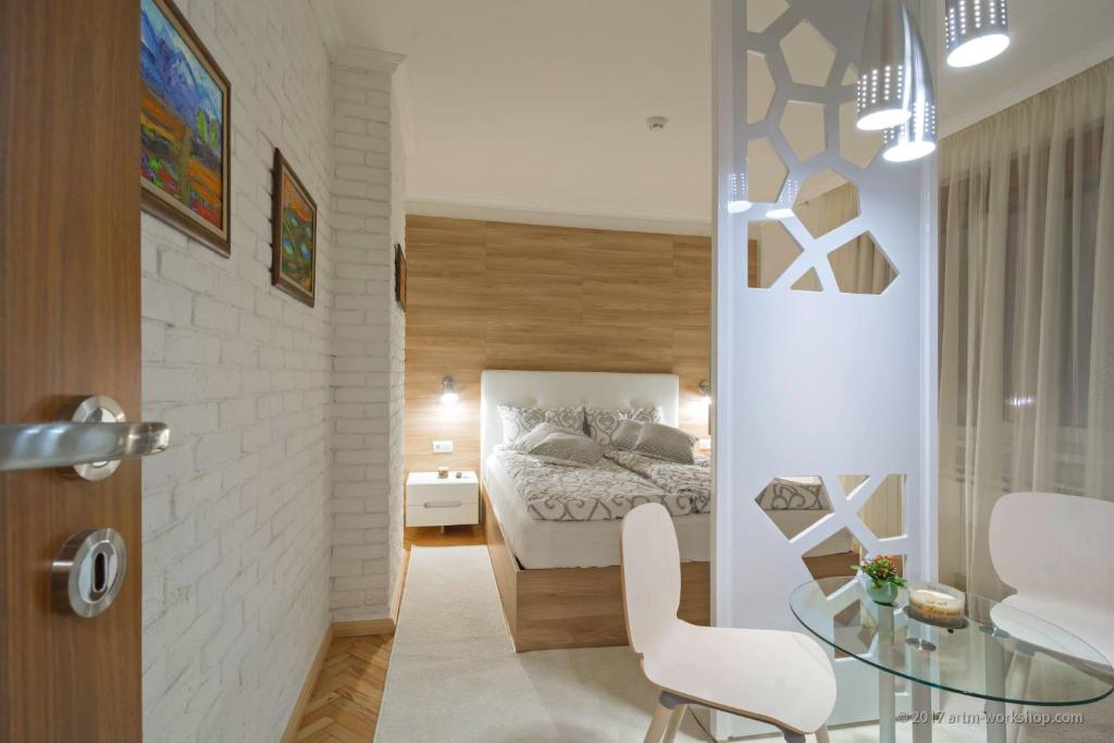 a bedroom with a bed and a glass table at Apartment ART in Veliko Tŭrnovo