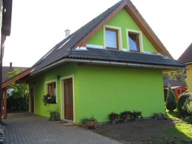 ein grünes Haus mit schwarzem Dach in der Unterkunft Iva ubytovanie in Liptovský Mikuláš