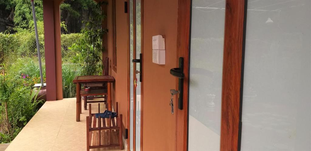an open door to a porch with a table and chairs at Yen Binh Homestay in Ninh Binh