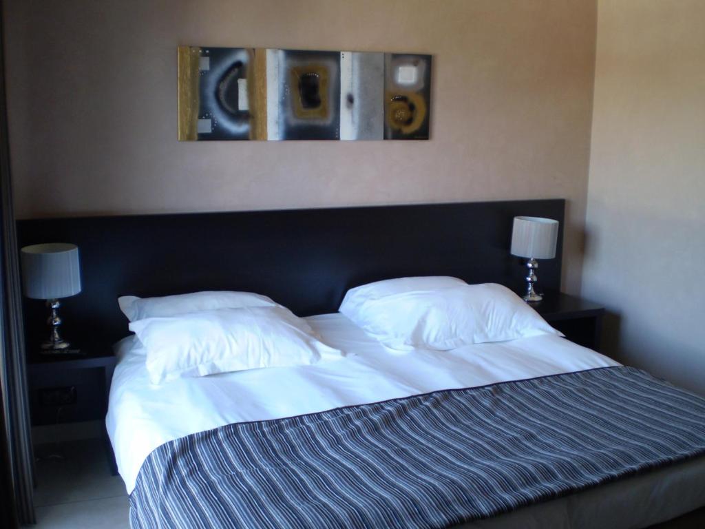 a bedroom with a large bed with two pillows at Augustin Marie in Bonifacio