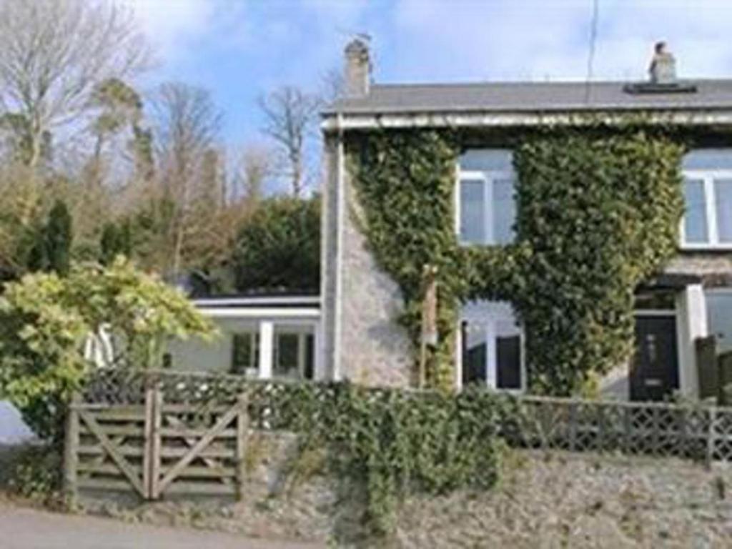 a house with ivy growing on the side of it at Arches B&B in St Austell